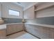 Bright mud room featuring custom cabinets, quartz countertops, blue subway tile backsplash, and modern finishes at 37200 N Cave Creek Rd # 1019, Scottsdale, AZ 85262