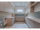 Bright mud room featuring custom cabinets, quartz countertops, blue subway tile backsplash, and modern finishes at 37200 N Cave Creek Rd # 1019, Scottsdale, AZ 85262