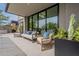 Covered outdoor patio featuring comfortable seating, sleek hardscaping, and views of the well-manicured backyard at 37200 N Cave Creek Rd # 1019, Scottsdale, AZ 85262