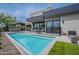 Modern backyard pool with a sleek design, black safety fence, and outdoor seating area at 37200 N Cave Creek Rd # 1019, Scottsdale, AZ 85262