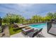 Stunning backyard featuring a pool, modern fire pit, lounge chairs, and desert landscaping at 37200 N Cave Creek Rd # 1019, Scottsdale, AZ 85262