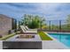 Relaxing poolside view featuring lounge chairs, a modern fire pit, and desert landscaping at 37200 N Cave Creek Rd # 1019, Scottsdale, AZ 85262