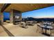 Restaurant interior with a stone wall, golf course view, and modern furniture at 37200 N Cave Creek Rd # 1019, Scottsdale, AZ 85262