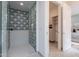 Elegant shower featuring modern tilework and a glass enclosure, next to an open closet for added convenience at 37200 N Cave Creek Rd # 1019, Scottsdale, AZ 85262