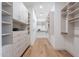 Spacious walk-in closet featuring custom shelving, drawers, and hardwood floors, for ample storage at 37200 N Cave Creek Rd # 1019, Scottsdale, AZ 85262