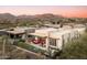 Expansive aerial shot of the desert community showing manicured landscaping and scenic mountain views at 37200 N Cave Creek Rd # 1034, Scottsdale, AZ 85262