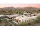 Luxury home with a pool and patio, set against a backdrop of mountains and a golf course at 37200 N Cave Creek Rd # 1034, Scottsdale, AZ 85262