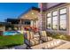 Beautiful backyard showcasing a pool, modern patio, and outdoor fire pit with comfortable seating at 37200 N Cave Creek Rd # 1034, Scottsdale, AZ 85262
