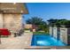 Lush backyard featuring a pool, waterfall feature, and comfortable seating around a fire pit at 37200 N Cave Creek Rd # 1034, Scottsdale, AZ 85262