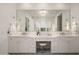 Elegant bathroom with double sinks, custom cabinets and a center makeup vanity at 37200 N Cave Creek Rd # 1034, Scottsdale, AZ 85262