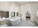 Bright bathroom featuring a soaking tub, patterned tile flooring, and a doorway leading to the bedroom at 37200 N Cave Creek Rd # 1034, Scottsdale, AZ 85262