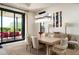Stylish dining area with a modern light fixture and sliding glass doors to a covered patio at 37200 N Cave Creek Rd # 1034, Scottsdale, AZ 85262