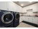 Spacious laundry room with new appliances, ample storage, and granite countertops at 37200 N Cave Creek Rd # 1034, Scottsdale, AZ 85262