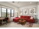Comfortable living room with a plush red sofa, stylish decor, and a large window at 37200 N Cave Creek Rd # 1034, Scottsdale, AZ 85262