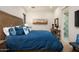 Comfortable main bedroom features a large wood headboard, patterned pillows, and an ensuite bathroom at 37200 N Cave Creek Rd # 1034, Scottsdale, AZ 85262
