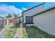 View of the backyard and side yard with patio, showing the home's exterior design at 3827 N 88Th Ln, Phoenix, AZ 85037