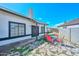 Backyard patio with stone flooring and outdoor seating, complemented by a view of the house at 3827 N 88Th Ln, Phoenix, AZ 85037