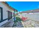 View of the backyard featuring a stone patio, seating area, and exterior walls at 3827 N 88Th Ln, Phoenix, AZ 85037