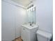 This bathroom includes a sink, toilet, mirror, lighting and closet at 3827 N 88Th Ln, Phoenix, AZ 85037