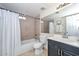 This bathroom includes a shower over a tub, window, toilet, sink and a mirror at 3827 N 88Th Ln, Phoenix, AZ 85037
