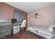This bedroom includes a bed, desk, dresser and storage shelves at 3827 N 88Th Ln, Phoenix, AZ 85037