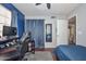 This bedroom includes a desk, gaming chair, PC, closet, mirror and doorway to a bathroom at 3827 N 88Th Ln, Phoenix, AZ 85037