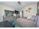This bedroom includes a bed, ceiling fan, desk, dresser and artwork at 3827 N 88Th Ln, Phoenix, AZ 85037
