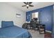 Bedroom with blue accent wall and space for a home office at 3827 N 88Th Ln, Phoenix, AZ 85037