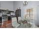 Kitchen with an adjacent dining area with stainless steel appliances, dark cabinets and tile flooring at 3827 N 88Th Ln, Phoenix, AZ 85037