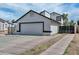White two story home with black trim and a large 2-car garage with driveway at 3827 N 88Th Ln, Phoenix, AZ 85037