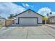 Front view of the garage showcasing the driveway and architectural details at 3827 N 88Th Ln, Phoenix, AZ 85037