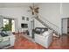 Bright living room featuring tile flooring, a ceiling fan, and staircase at 3827 N 88Th Ln, Phoenix, AZ 85037