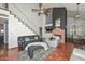 Open living room with a fireplace, staircase, and comfortable seating arrangements at 3827 N 88Th Ln, Phoenix, AZ 85037