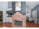 Living room with a stone fireplace, dining room, and open floor plan at 3827 N 88Th Ln, Phoenix, AZ 85037