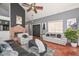 Spacious living room with a brick fireplace, tile flooring, and comfortable seating at 3827 N 88Th Ln, Phoenix, AZ 85037