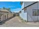 Side yard with bricks and metal gate, good for storage at 3827 N 88Th Ln, Phoenix, AZ 85037