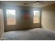 Bright bedroom with carpet, art, and large windows provides light and style for restful nights at 4136 N 113Th Dr, Phoenix, AZ 85037