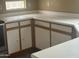 Kitchen featuring white cabinets, light countertops, and modern fixtures offers a clean and functional cooking area at 4136 N 113Th Dr, Phoenix, AZ 85037