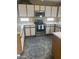 Updated kitchen features white cabinets, stainless steel appliances, and stylish countertops, creating a modern cooking space at 4136 N 113Th Dr, Phoenix, AZ 85037