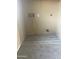 Laundry room with gray flooring and utility connections is ready for appliances to ensure convenient chores at 4136 N 113Th Dr, Phoenix, AZ 85037