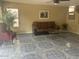 Living room with tile floor, sofa, and plant creates a warm and inviting atmosphere at 4136 N 113Th Dr, Phoenix, AZ 85037