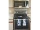 Updated stainless steel oven and microwave with decorative backsplash and floral towels at 4136 N 113Th Dr, Phoenix, AZ 85037