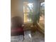 Bright sunroom with tile flooring, a large window, and an accent chair creates a cozy and inviting space at 4136 N 113Th Dr, Phoenix, AZ 85037
