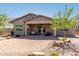 Well-maintained backyard with desert landscaping and covered patio with fan and seating at 4361 S Electron --, Mesa, AZ 85212