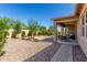 Desert landscaped backyard featuring a covered patio with outdoor seating at 4361 S Electron --, Mesa, AZ 85212