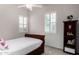 Bright bedroom with a twin bed, shuttered windows, plush carpeting, and a decorative bookshelf at 4361 S Electron --, Mesa, AZ 85212