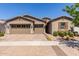 Charming home with a three-car garage, desert landscaping, and tan exterior at 4361 S Electron --, Mesa, AZ 85212