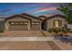 Charming single-story home featuring a three-car garage and brick paved driveway, enhanced by a lovely desert landscape at 4361 S Electron --, Mesa, AZ 85212