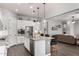 A modern kitchen boasts white cabinets, stainless steel appliances, and a granite island with pendant lighting at 4361 S Electron --, Mesa, AZ 85212