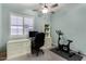 Home office with custom built-ins, a ceiling fan, and an exercise bike for convenient workouts at 4361 S Electron --, Mesa, AZ 85212